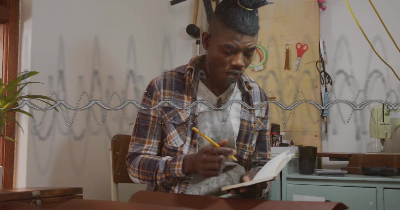 Vertical video: Man with pencil glancing at notebook, sketching leather while animated lines guide