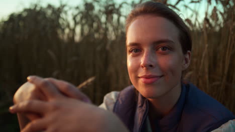 smiling farmer posing wheat field. happy woman in golden sunlight portrait.