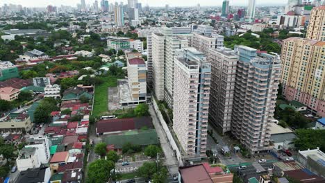 West-Crame-district-in-asian-town-Quezon-City,-modern-high-rises,-aerial-orbit