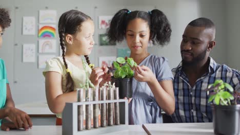 video of happy african american male teacher and class of diverse pupils during biology lesson