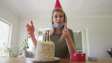 woman blowing candles on the cake at home