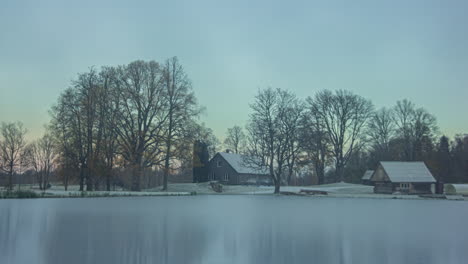 houses along a lake during spring to summer, fall and winter in a time lapse