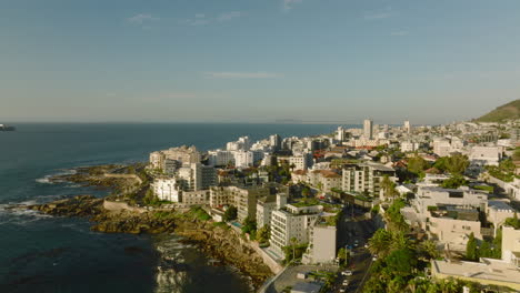 Sliding-reveal-of-multistorey-apartment-buildings-or-hotels-at-sea-coast-in-tourist-destination.-Cape-Town,-South-Africa