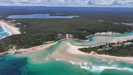 Expansive aerial orbit of Sussex Inlet, NSW, Australia, with blue waters and curving sandbanks meeting open ocean