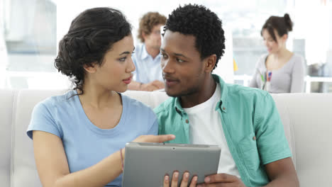 Colleagues-chatting-on-the-sofa-with-tablet-