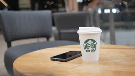 starbucks coffee and phone on a table