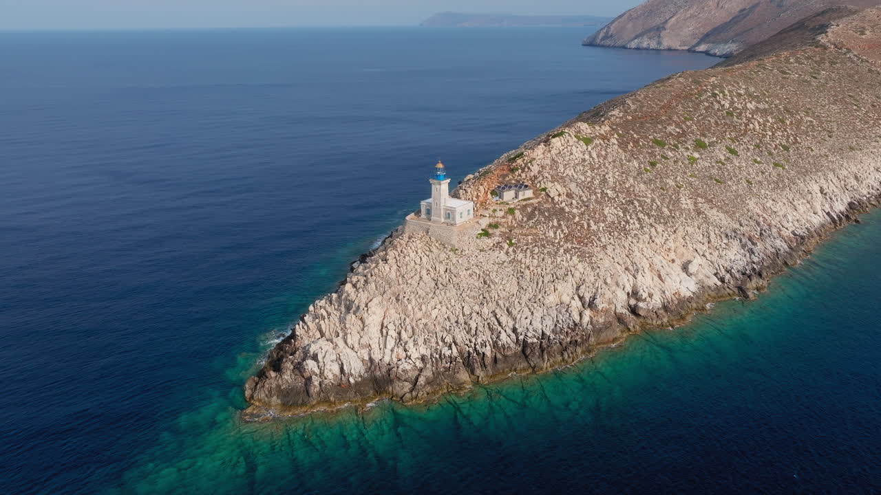 Sharp rocky cliffs of Cape Tainaron drop into Aegean Sea, deep blue coastline glistens below