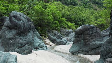 natural blue boulders around the narrow stream in los charcos de nizao, dominican republic