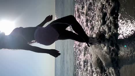 Unrecognizable-black-woman-walking-on-beach