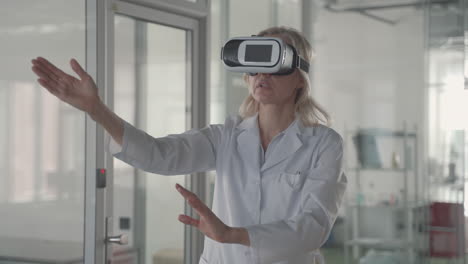 a blonde, middle aged female doctor navigates through data with vr glasses 1