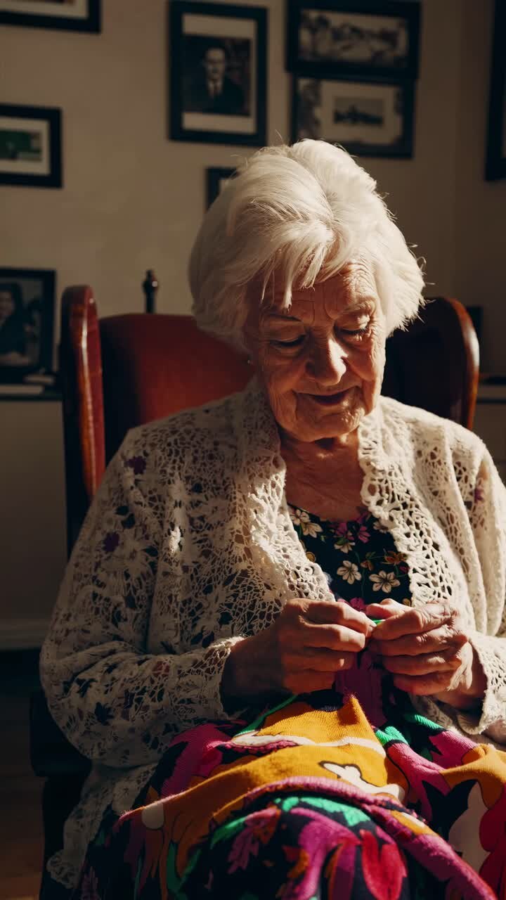 Warm, nostalgic video of an elderly woman knitting, captured from a low angle