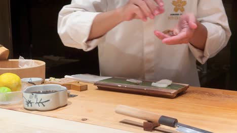 chef prepares sushi with precision and care