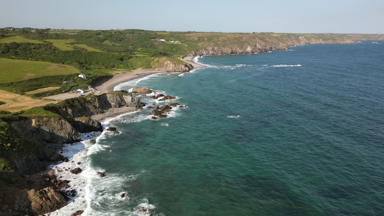 A drone view of the rugged coastline on the south coast of Cornwall, England near the village of Kuggar and Kennack Sands popular with holidaymakers.