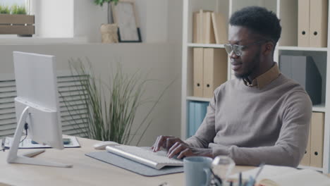 man working on computer in office