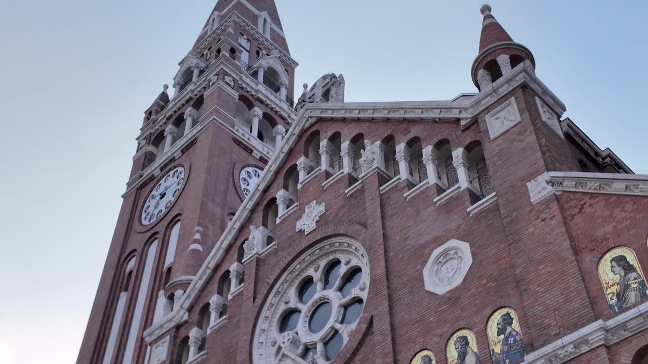 Detailed view of the Votive Church’s ornate facade in Szeged, Hungary, highlighting its intricate Neo-Romanesque design