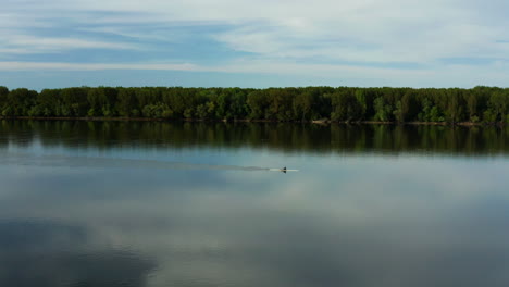 serene danube river with man boating near vukovar in croatia