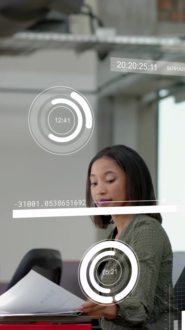 Vertical video: Woman tapping docs at red table making HUD moving passer blurring reading for work