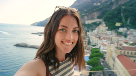 happy woman taking selfie at amalfi coast viewpoint