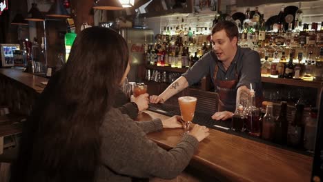 people ordering drinks at a bar