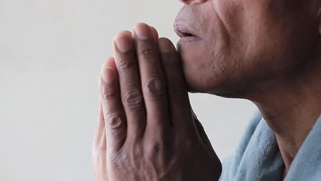close-up of a person praying or in deep thought