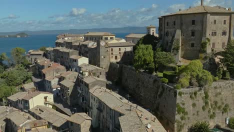 Aerial-around-the-Rocca-Farnese-Castle-and-old-town-of-Capodimonte-on-Lake-Bolsena,-Province-of-Viterbo,-Italy