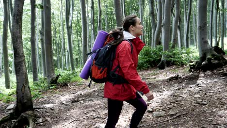 a young tourist woman walking on a mountain path