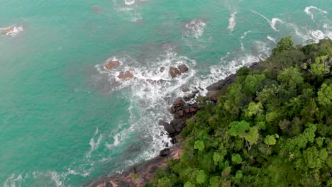 beautifull drone footage of turquoise water crashing rocks in brasil