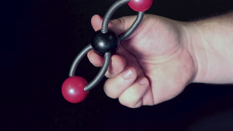 Ball-and-stick-model-of-carbon-dioxide-being-moved-around-on-a-black-lab-bench