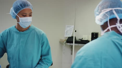 surgical team working on patient in hospital operating theatre