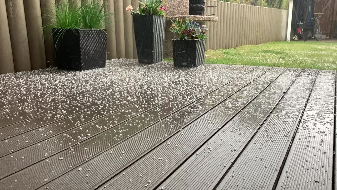 a hailstorm comes down in a garden