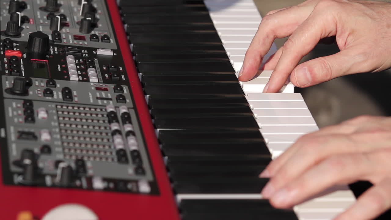 hombre tocando el teclado piano cerca de las manos