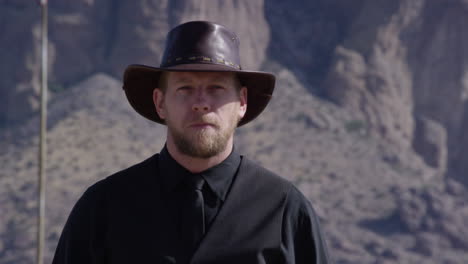 Cowboy-spitting-in-front-of-mountain-background