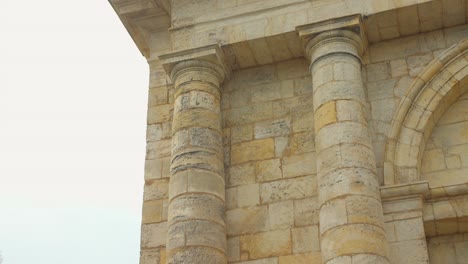 Low-angle-shot-of-La-Rochelle-structure-over-royal-door-in-France-under-blue-bright-sky