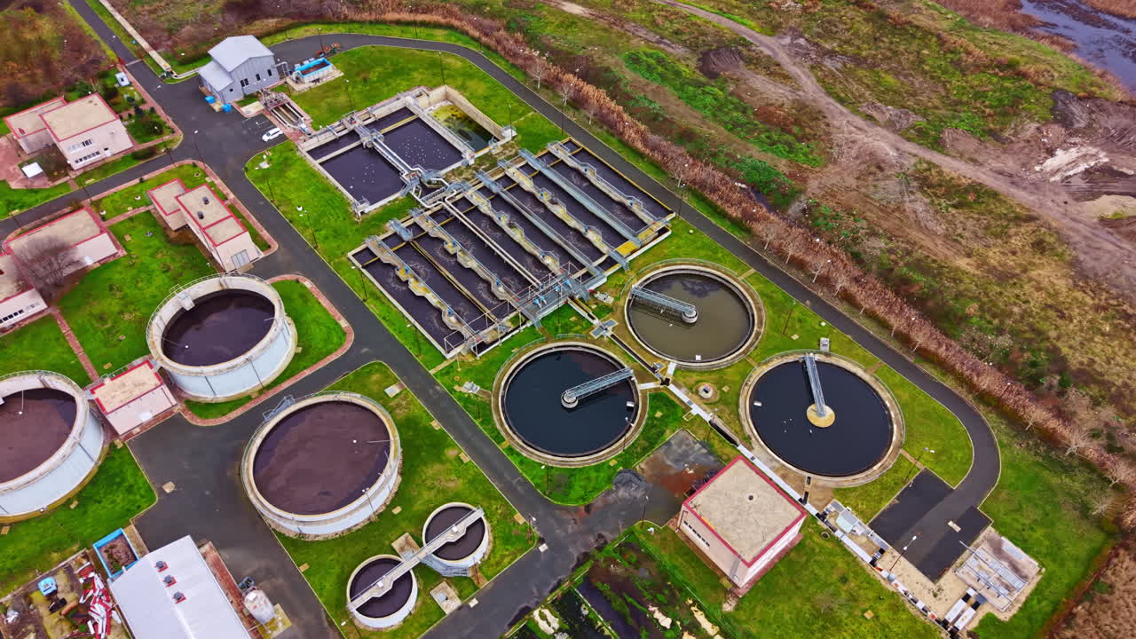 Water treatment facility located on open land with various processing tanks and buildings during daytime