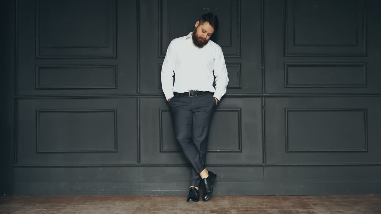 Gentleman posing in studio. Portrait of stylish handsome man with beard in studio
