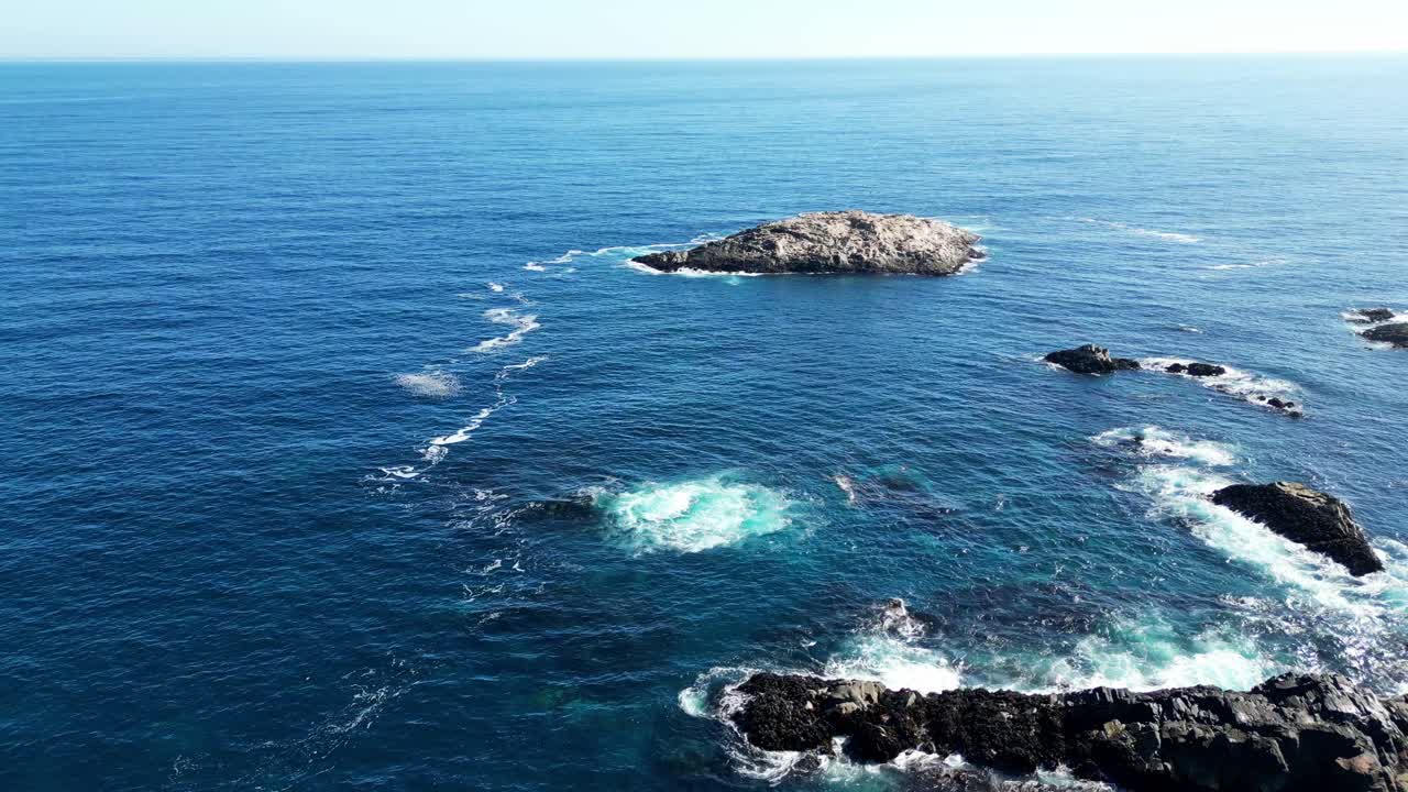 Aerial drone view of Isla de los Lobos, a striking white rocky island off the Chilean coast near Los Vilos