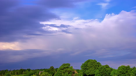 colorful timelapse of clouds moving over a green forest in europe in summertime