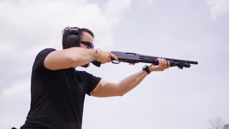 low angle view of person shoot shotgun with muzzle blast shockwave visible