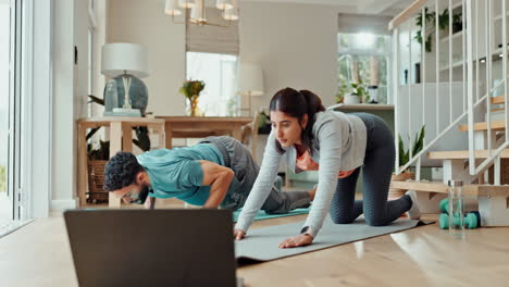 couple doing yoga at home with online class