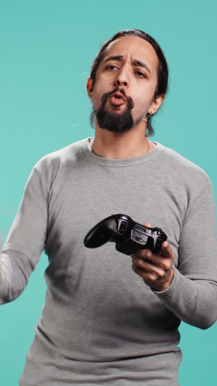 Vertical video Cheerful player happy after winning gaming console game, shaking fist,
