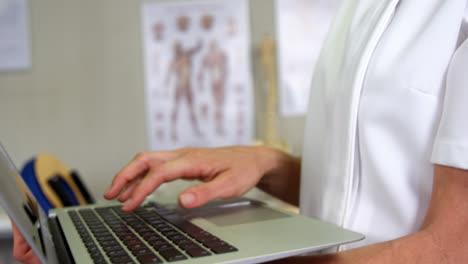 Female-physiotherapist-using-laptop