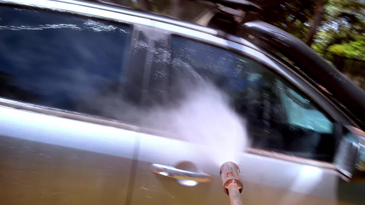 Point of View (POV) clip of pressure washing the 4x4 on a sunny day