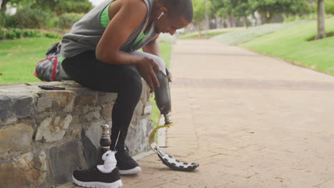 side view man putting on his prosthetic leg