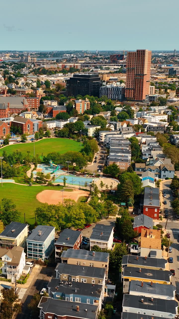 Densely built low-rise architecture of the city on sunny day. Cityscape of Cambridge, Massachusetts, USA from bird's eye view.. Vertical video