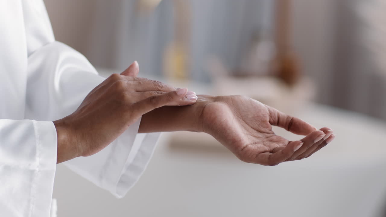 Woman applying lotion to her wrist