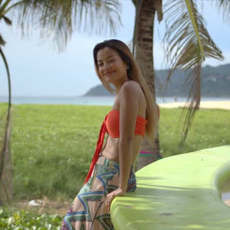 stylish female leaning on border on beach