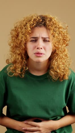 young woman experiencing stomach pain or discomfort