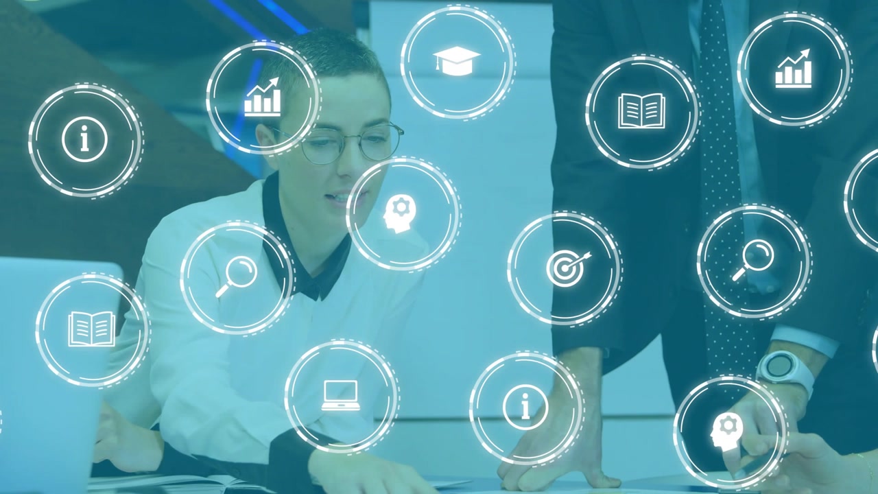 Seated woman pointing, team reviewing plans for business, laptop chart icons floating across frame