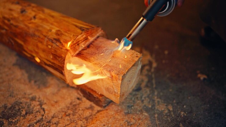 Portable Gas Blowtorch Being Used To Treat Wood. Close-up Shot