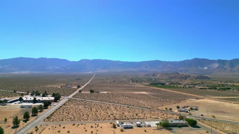 Highway-Through-Deserted-Landscape,-Lucerne-Valley-In-California,-USA---Aerial-Drone-Shot